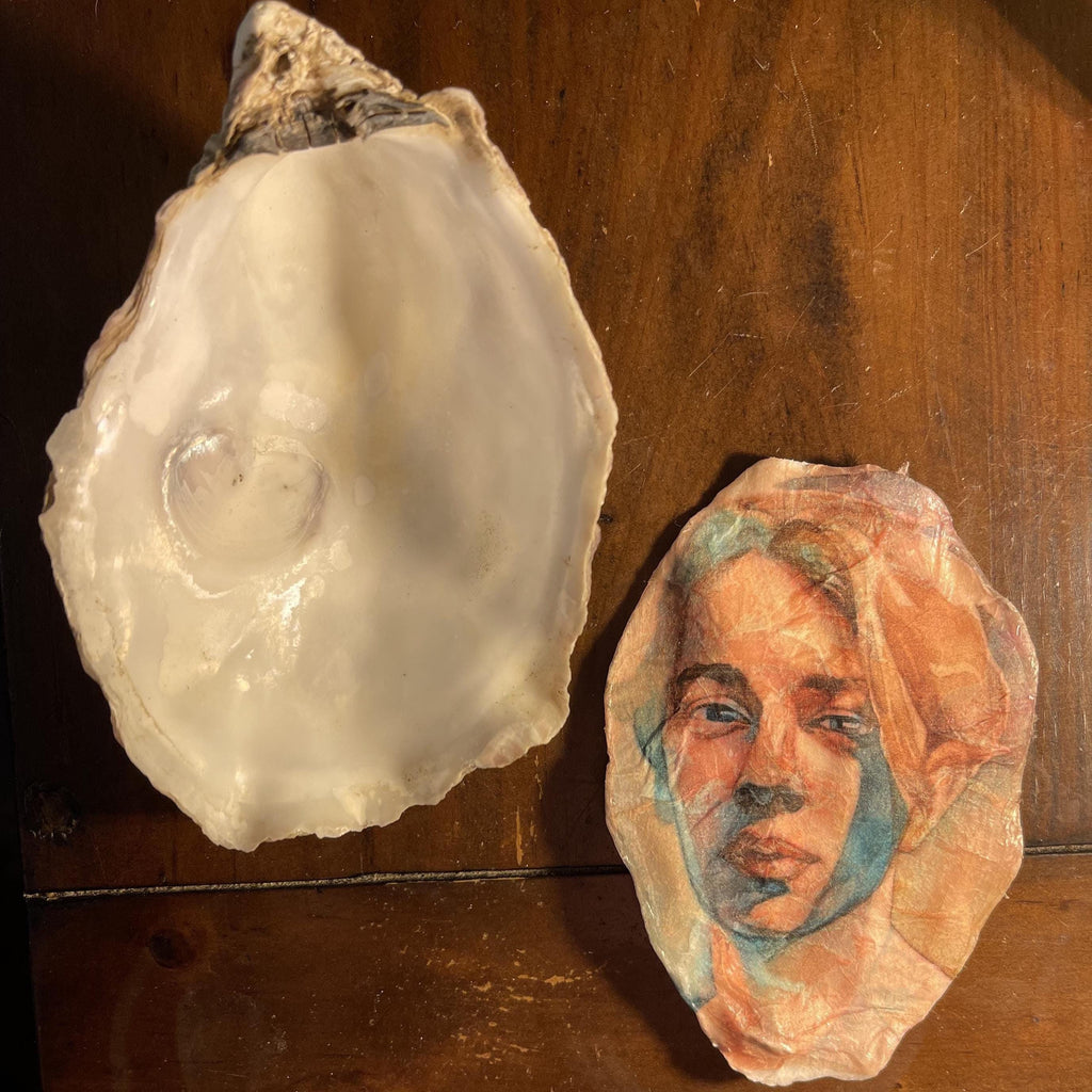 Two oyster shells displayed on a wooden surface, with one shell showing a glossy white interior and the other featuring a painted portrait of Tom Odel, a musician in soft peach, blue, and brown tones.